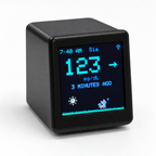 Black GlycoFox desktop glucose display showing a sample reading and animated fox