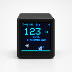 Front view of a black GlycoFox desktop glucose display with visible sample data